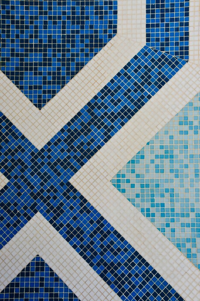 Intricate geometric mosaic with blue and white tiles, perfect for interior design concepts.